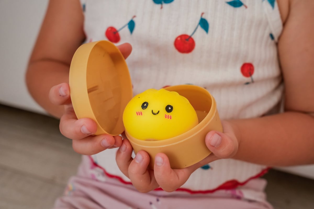 Child holding the advent calendar and squishy toys